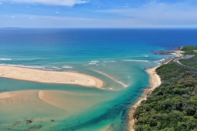 Aerial photo of turquoise water and sandbanks at the inlet entrance near Bastion Point, Mallacoota.